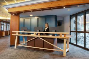 a woman sitting at a desk in an office at Hotel Euroski Mountain Resort & Spa in Soldeu +159 photos