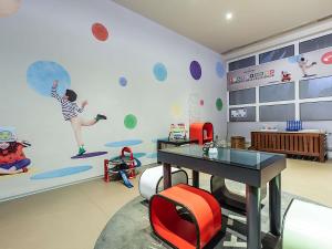 a room with a table and a wall with planets at Novotel Setubal in Setúbal