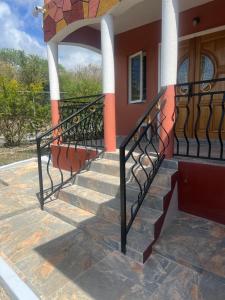a set of stairs leading to the front door of a house at Private Executive Master Suite - Parham, Antigua in Vernons