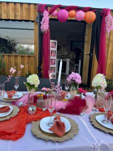 a table with plates of food and flowers on it at Samosiejka SPA Słońsko in Słońsko