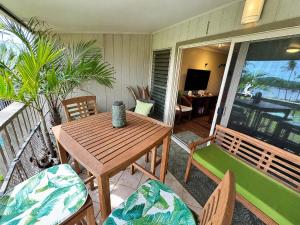 a porch with a wooden table and chairs on a balcony at Wavecrest - 4BR Condos - Sleeps 12 in Kaunakakai +36 photos