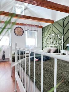 a bedroom with a white bed and green walls at Suite House - Magnolia - Oak - Sage in Bayreuth