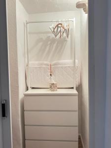 a white dresser in a hallway with a shelf at Suite House - Magnolia - Oak - Sage in Bayreuth +43 photos