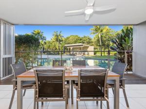 a dining room with a table and chairs on a patio at Drift North Beachfront Apartments - Private Apartments in Kingscliff