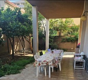 a table and chairs sitting on a patio at Tina' S House in Cagliari