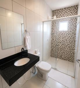 a bathroom with a sink and a toilet and a shower at Ondas do Preá - 700m da Praia - 12 km de Jeri in Prea +23 photos