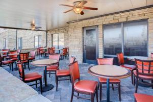 a restaurant with tables and chairs and a brick wall at SpringHill Suites Pigeon Forge in Pigeon Forge