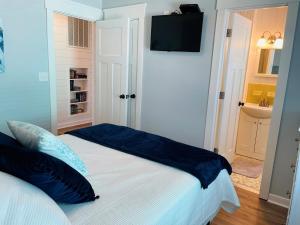a white bed with blue pillows in a room at 3 4 Time in Holden Beach