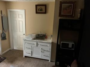 a kitchen with a sink and a white cabinet at Guest Suites in Conley