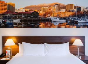 a hotel room with a bed and a harbor at Mantra Hobart Airport in Hobart +14 photos