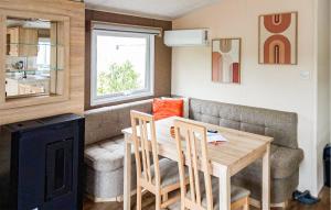 a small living room with a table and a couch at 2 Bedroom Cozy Stacaravan In Makkum in Makkum