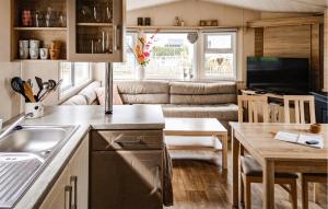 a kitchen and living room in a tiny house at 2 Bedroom Cozy Stacaravan In Makkum in Makkum