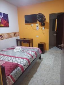a bedroom with a bed and a fan on the wall at Hotel capital in Florencia