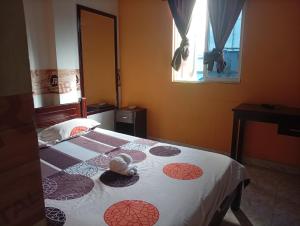 a bedroom with a bed in a room with a window at Hotel capital in Florencia