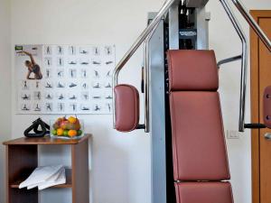 a refrigerator in a room with a table with a bowl of fruit at Novotel Roma Est in Rome +203 photos