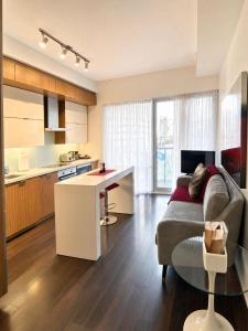 a kitchen and living room with a couch and a table at Union Centre Hotel & Suites in Toronto +115 photos