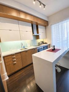 a kitchen with a white counter top and wooden cabinets at Union Centre Hotel & Suites in Toronto