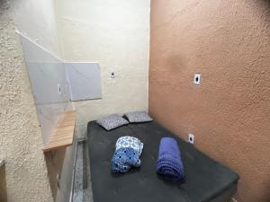 a room with two blankets and pillows on a bed at Recanto Carioca Aconchegante in Rio de Janeiro +6 photos