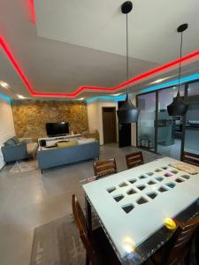 a living room with a ping pong table in the middle at Woodloft in Lagos