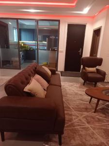 a living room with a couch and a chair at Woodloft in Lagos