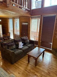 a living room with a couch and a coffee table at Bear Loads of Fun in Sevierville