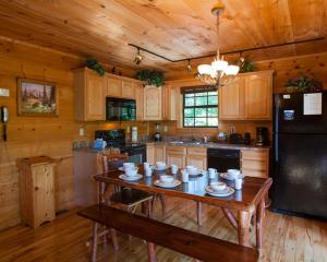 a kitchen with a table with dishes on it at Bear Loads of Fun in Sevierville