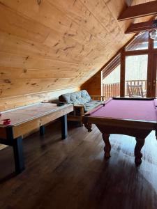 a room with two ping pong tables in a cabin at Bear Loads of Fun in Sevierville