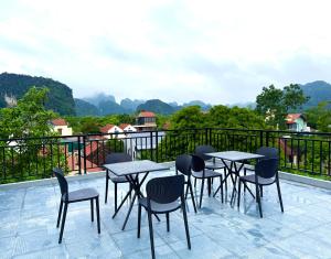 a patio with tables and chairs on a balcony at Tam Coc Sunny House in Vũ Lâm