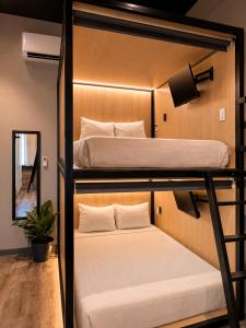 two bunk beds in a room with a mirror at Boxstel - Modern Stay Hotel Downtown El Paso in El Paso +9 photos