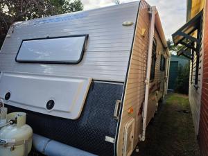 a white tub sitting inside of a trailer at Luxury Caravan at 10 in Oakleigh