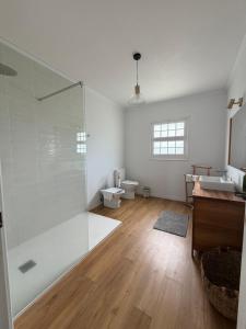 a bathroom with a shower and a toilet and a sink at Hydrangea House in Água de Pau +13 photos