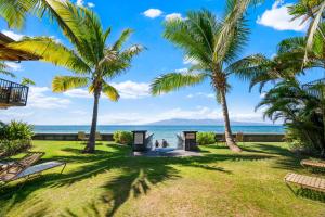 a view of the ocean from a resort with palm trees at Maui Sands 3C in Honokowai