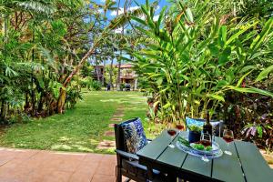 a green table with a plate of food on it at Maui Sands 3C in Honokowai
