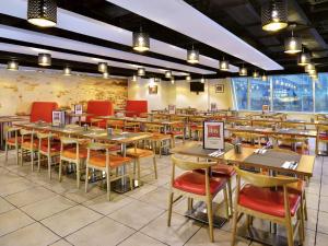 a restaurant with tables and chairs in a room at ibis Hong Kong North Point in Hong Kong