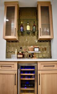 a kitchen with wooden cabinets and an oven at Casa Gia- Quiet Luxury Biltmore Area - Heated Pool in Phoenix