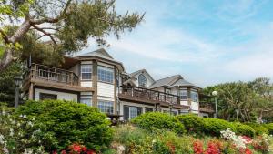 a large house with balconies and bushes at Ganghwa Western Beach Pension in Incheon