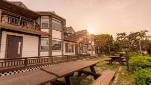 a wooden picnic bench in front of a building at Ganghwa Western Beach Pension in Incheon +10 photos