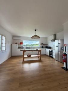 a kitchen with a table in the middle of a room at Hydrangea House in Água de Pau