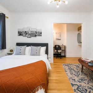 a bedroom with a large bed and a desk at High Falls Studio TV Kitchen Downtown Rochester in Rochester
