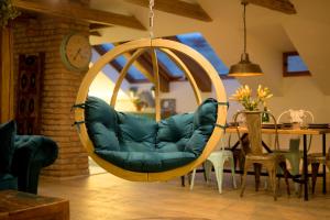 a hanging chair in a living room with a table at Bohemian Chic 2 Bedroom 2 Bathroom Loft with Hanging Chair in Prague