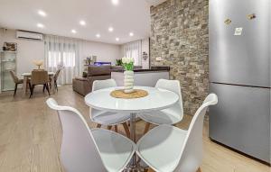 a kitchen and living room with a white table and chairs at Villa Villaplana in Fortuna