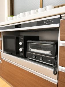 a microwave oven sitting inside of a kitchen at Hotel Airport Komatsu in Komatsu