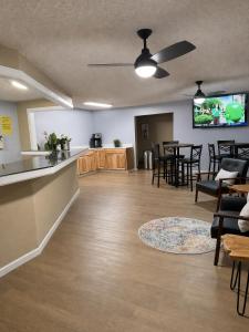 an empty waiting room with tables and chairs at Super 8 by Wyndham Blackwell in Blackwell