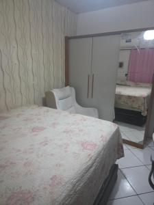 a bedroom with a large bed and a mirror at Pousada de Isa in Palhoça +7 photos