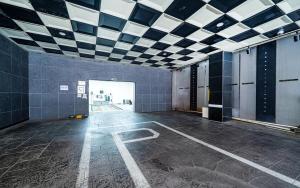an empty room with a tiled ceiling and a door at Hotel The Fine in Uijeongbu