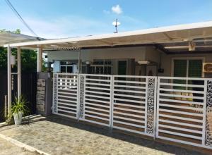 a white fence in front of a house at Homestay 4H Perlis in Kangar