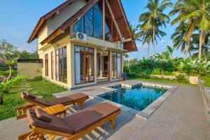 a villa with a pool and a house at Nandikara Villa in Payangan