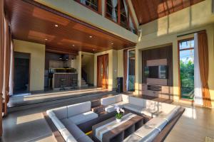 a large living room with a couch and a tv at Nandikara Villa in Payangan