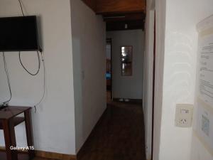a hallway with a wall with a tv on a wall at Alojamiento UMA in Puerto Iguazú