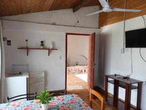 a dining room with a table and a ceiling fan at Alojamiento UMA in Puerto Iguazú